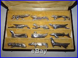 12 portes-couteaux ART DECO en métal argenté. Sandoz. En coffret