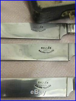 Coffret de 18 couteaux de table manche ébène virole métal argenté